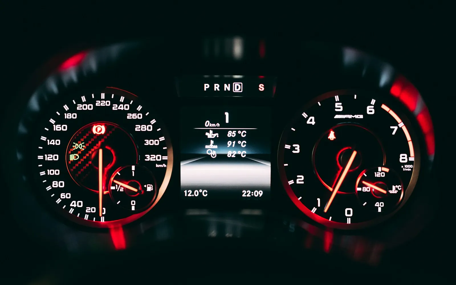 Illuminated car instrument cluster with speedometer, rev counter and engine temperature readouts