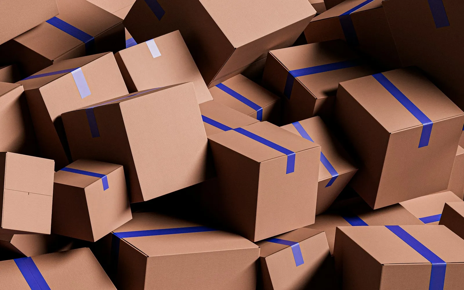 Pile of brown cardboard shipping boxes sealed with blue tape