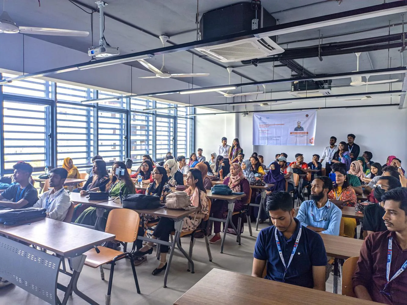 Students seated in a classroom attending a design thinking workshop session