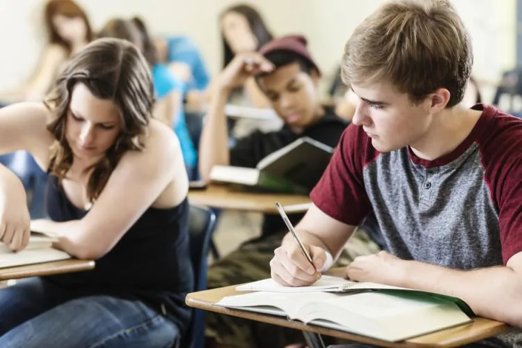 Students working on their own answers at desks in a classroom