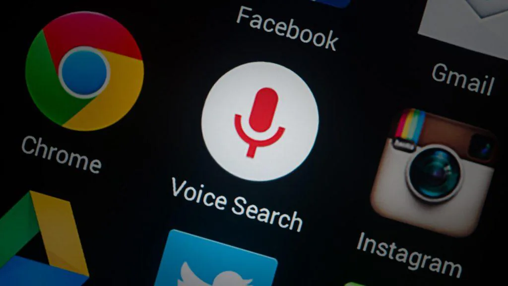 Close-up of a phone screen showing a Voice Search app icon among Chrome, Facebook, Gmail and Instagram icons