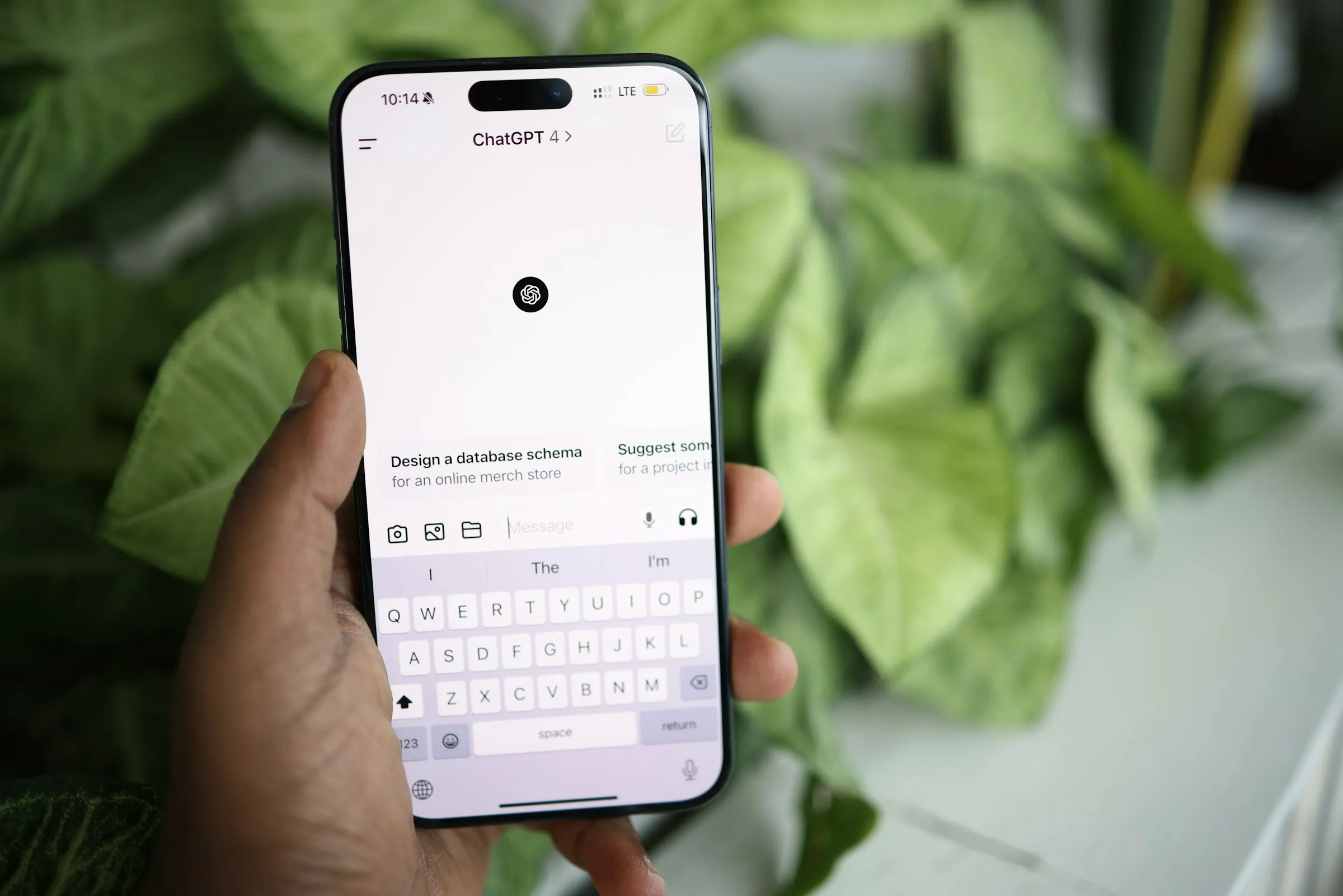Hand holding a phone open in the ChatGPT app